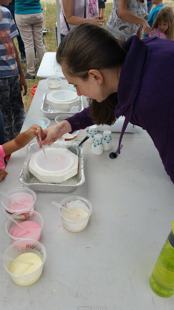 Girl helping others do water experiment