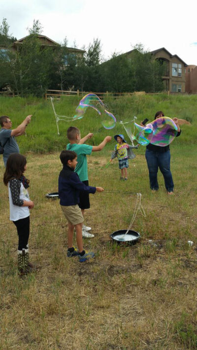 happy children playing with big bubbles