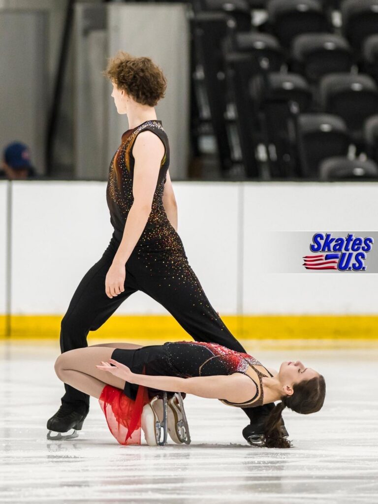 Jane Calhoun and her partner perform an expressive pose during a figure skating competition.
