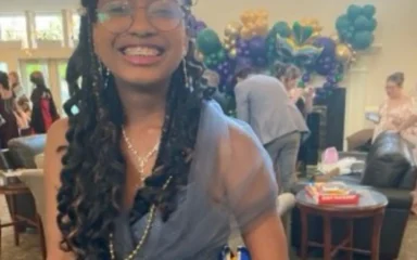 Darray smiling in a fancy dress.